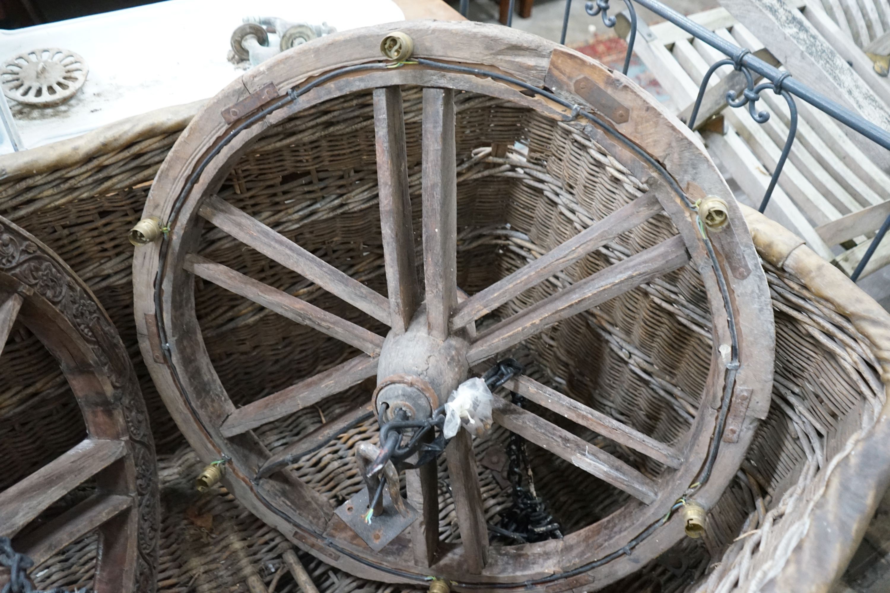 A pair of Continental carved hardwood cartwheels converted to ceiling lights, diameter 83cm